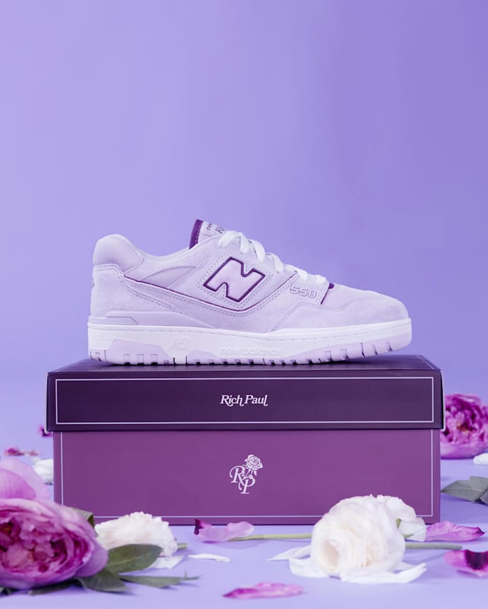 Side view of a purple and white New Balance sneaker.